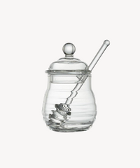 Glazen honingpot met lepel